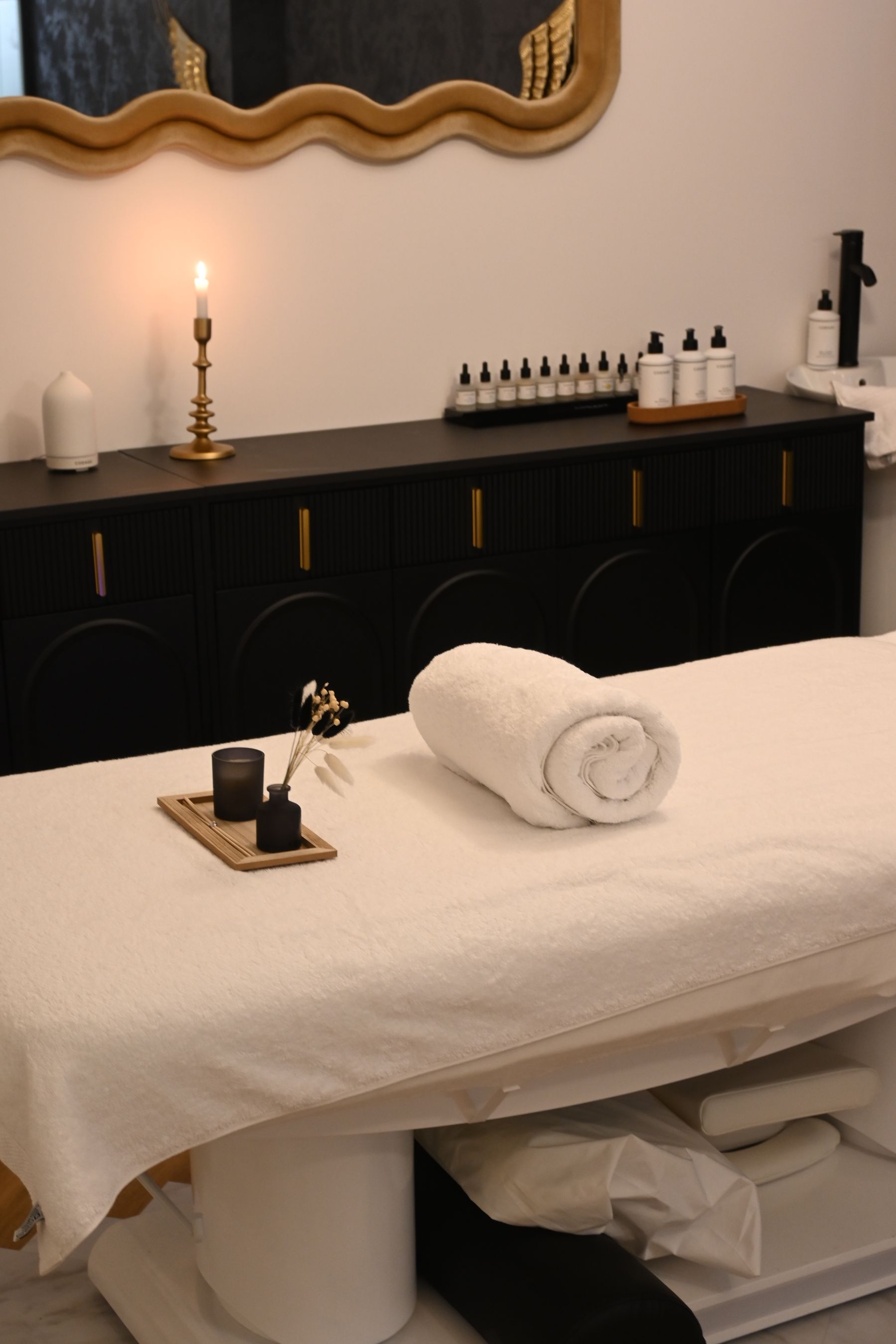 A calm, prepared treatment room in warm neutral tones