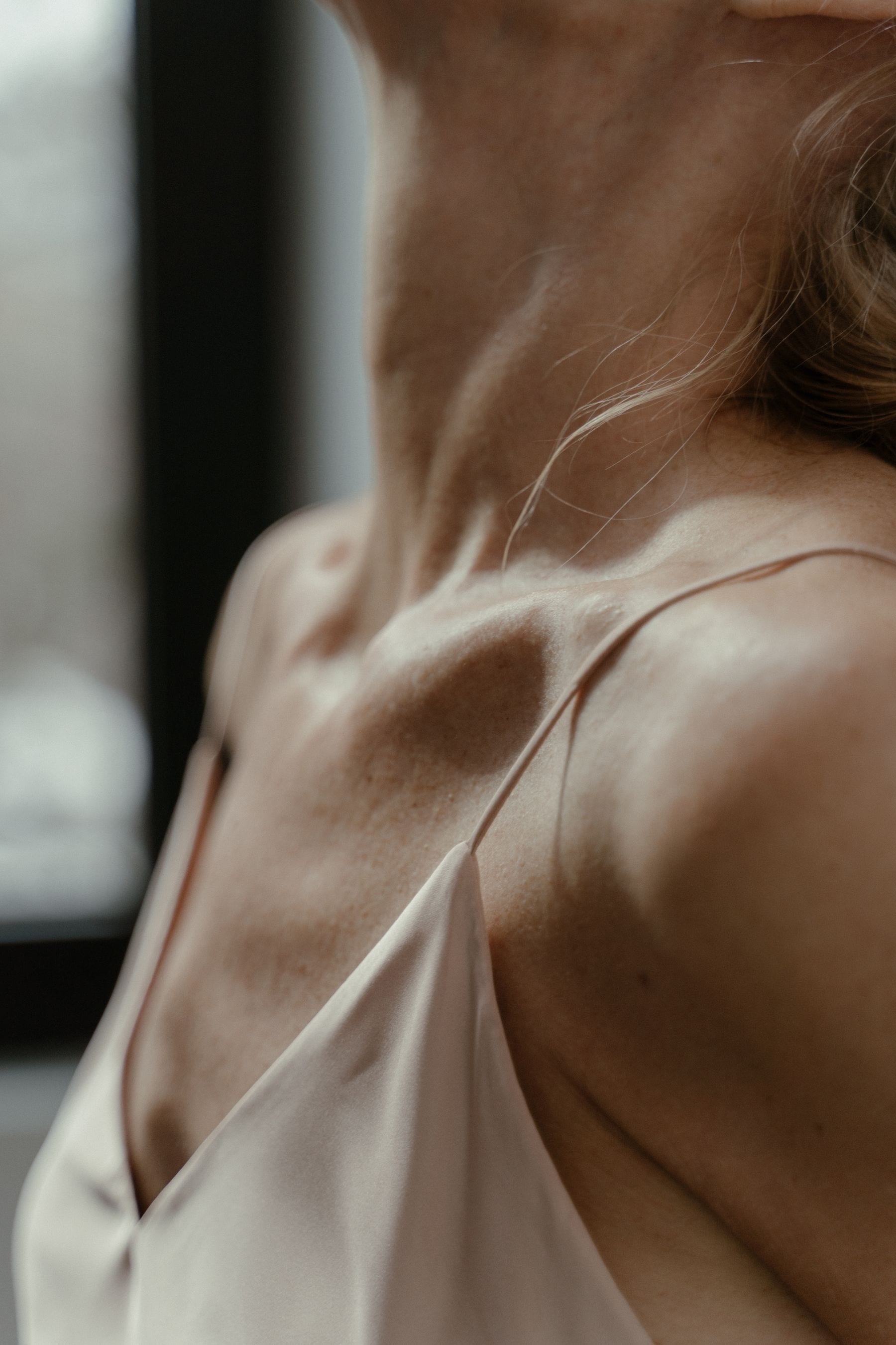 Warm natural light across a collarbone and shoulder